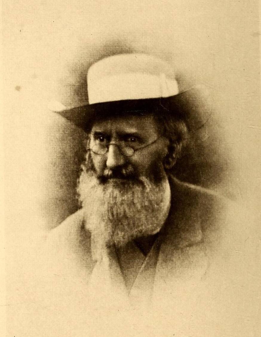 Old sepia portrait of Richard Spruce, an elderly man with a white beard, spectacles and a pale brimmed hat.