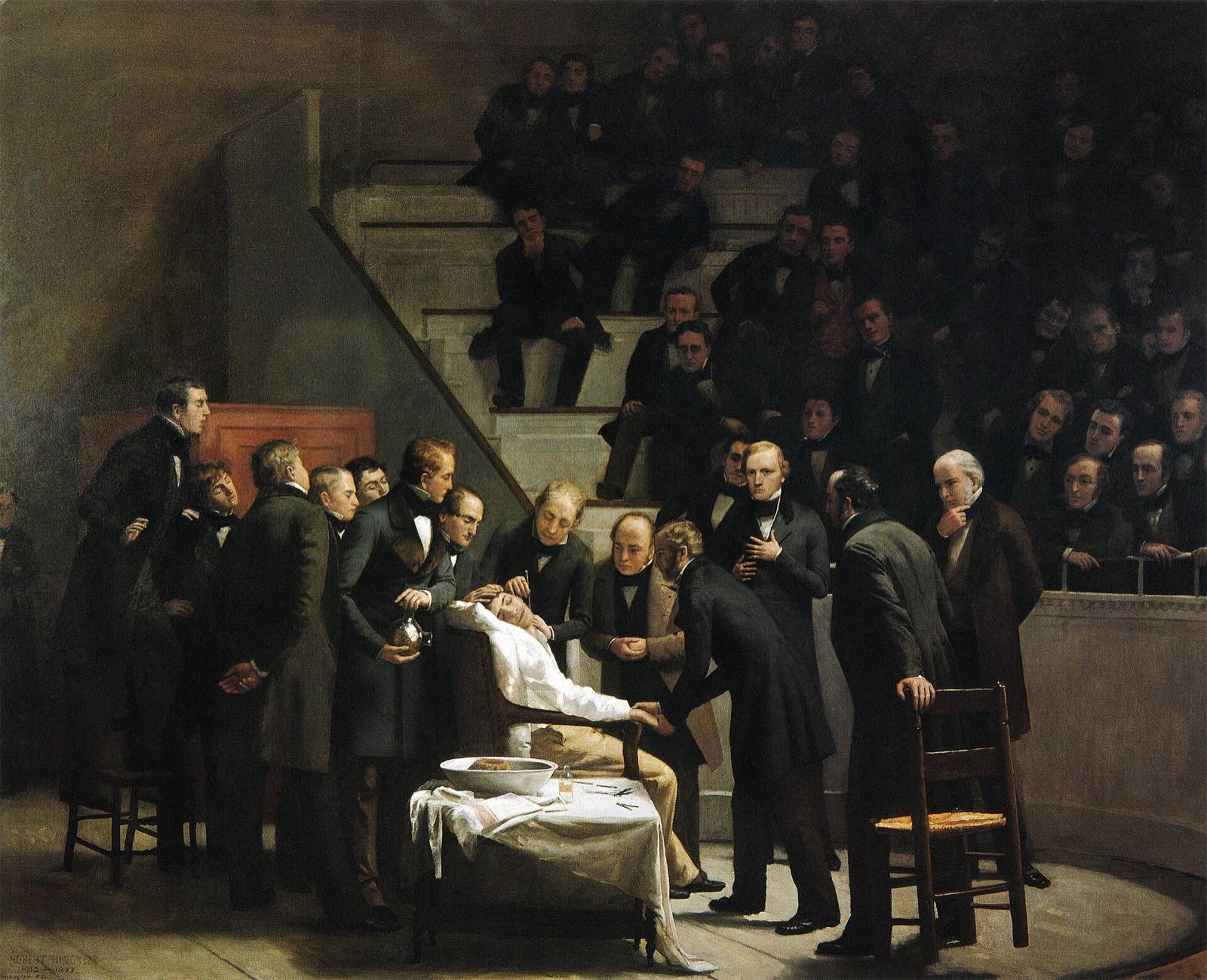Oil painting: doctors in dark frock coats surround an anaesthetised patient in a surgical chair, before a crowded tiered theatre.
